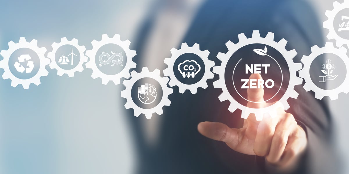 Net zero and carbon neutral concept. Net zero greenhouse gas emissions target. Climate neutral long term strategy. Businessman touching on net zero icon with decarbonization icon on smart background.