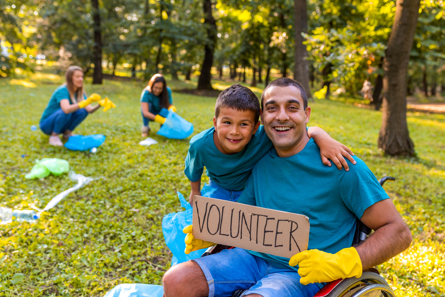 Volunteers: men holds Volunteer sign. Community involvement. Recycling.