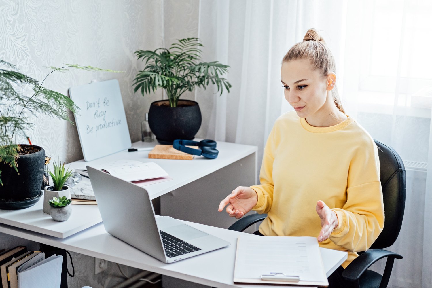 Online Side Hustle Ideas To Make Money Fast. Young woman speaking in front of laptop as consultant, blogger, recording video tutorial or training course. Earn extra money, money making.