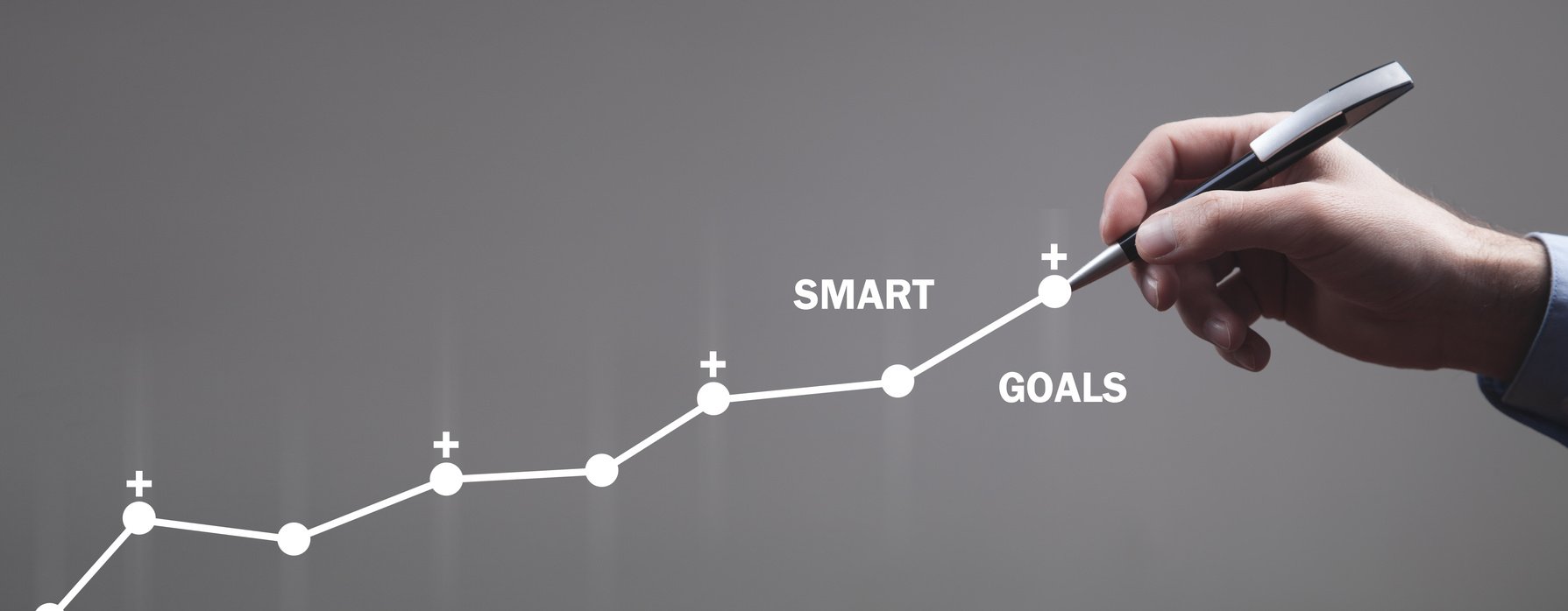 Male hand drawing growth graph. Smart goals