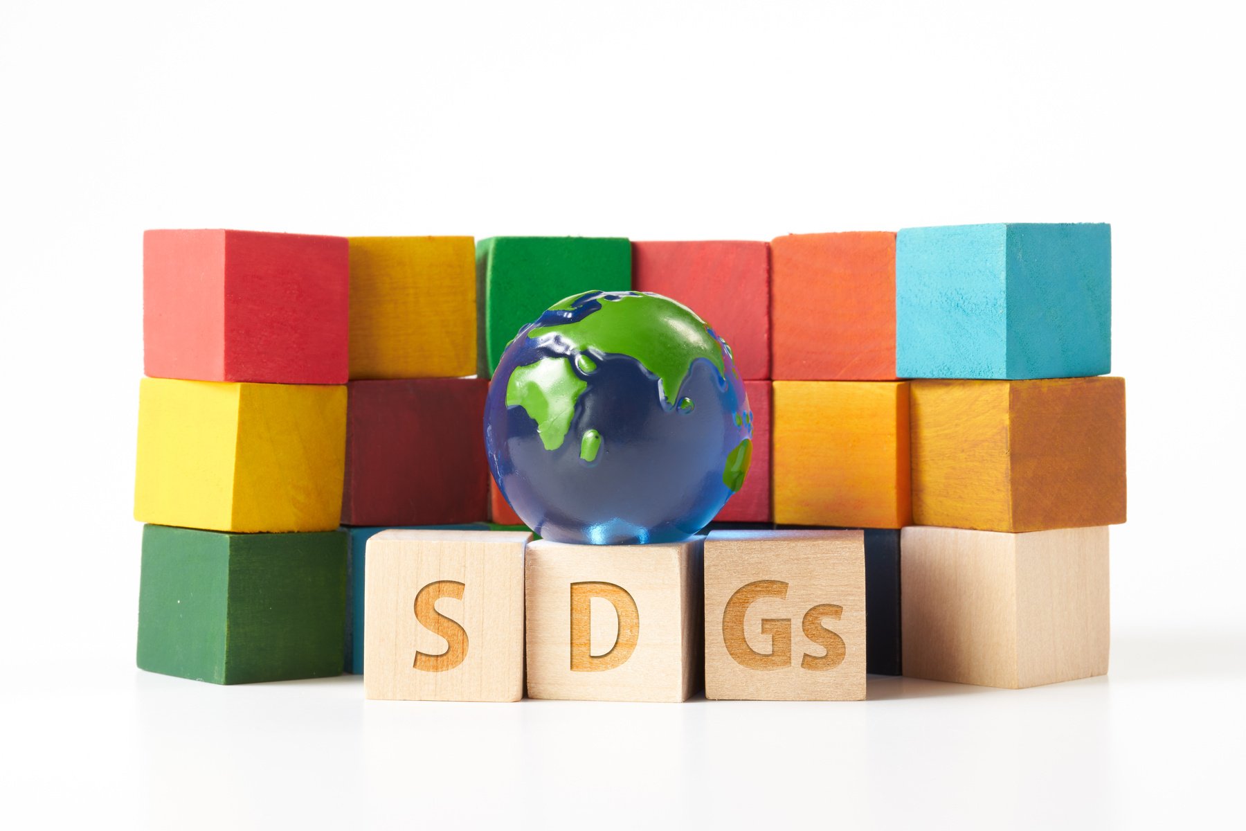 globe and a wooden cube stamped with the letters SDGs.