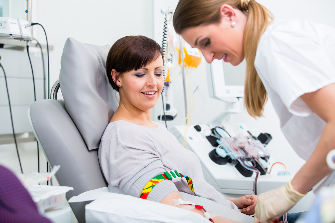 Doctors Assistant Checking Access at Female Blood Giver